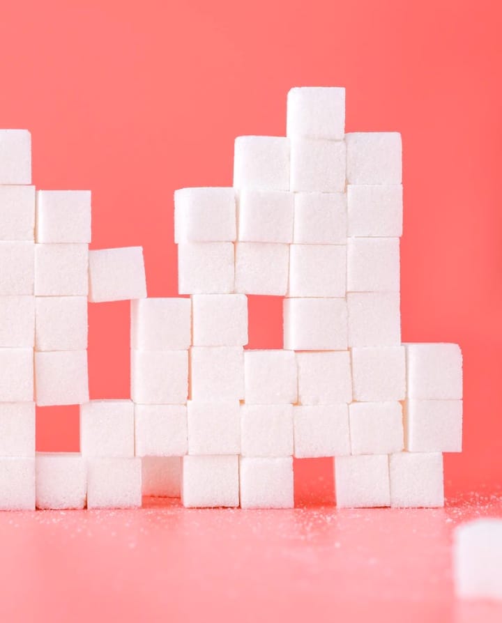 sugar cubes stacked with pink background
               