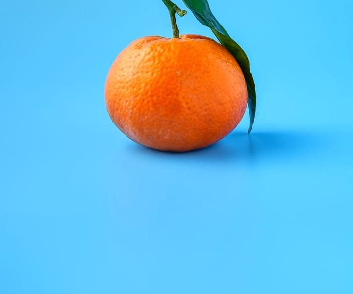 An orange with a leaf